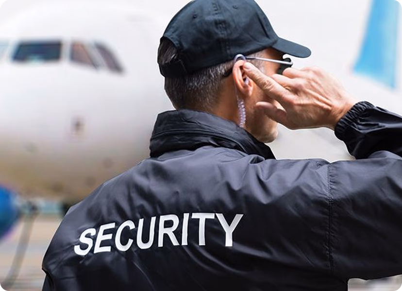 Security operations center with multiple team members monitoring large screen displays.